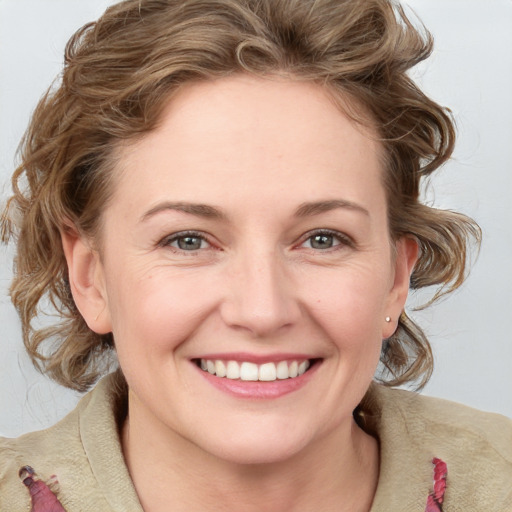 Joyful white young-adult female with medium  brown hair and blue eyes