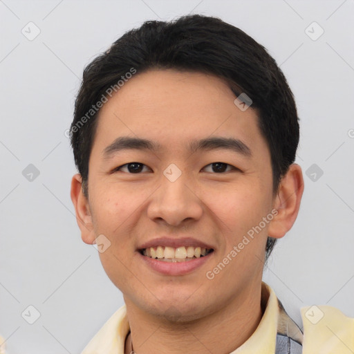 Joyful asian young-adult male with short  black hair and brown eyes