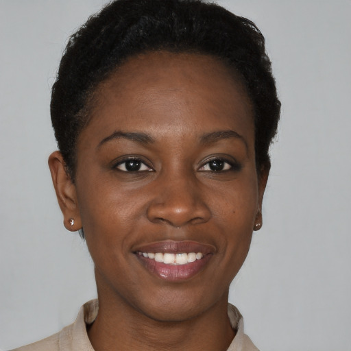 Joyful black young-adult female with short  black hair and brown eyes