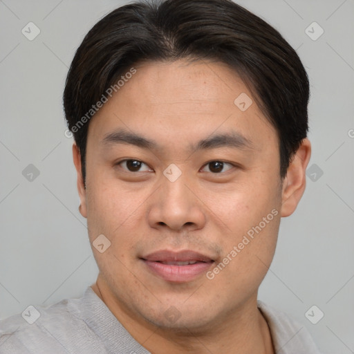 Joyful asian young-adult male with short  brown hair and brown eyes