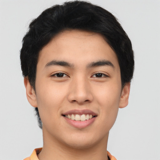 Joyful asian young-adult male with short  black hair and brown eyes