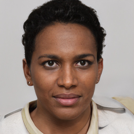 Joyful black young-adult female with short  brown hair and brown eyes
