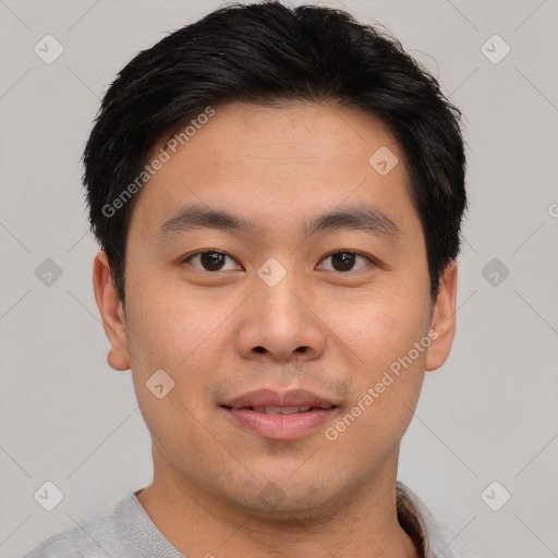 Joyful asian young-adult male with short  brown hair and brown eyes