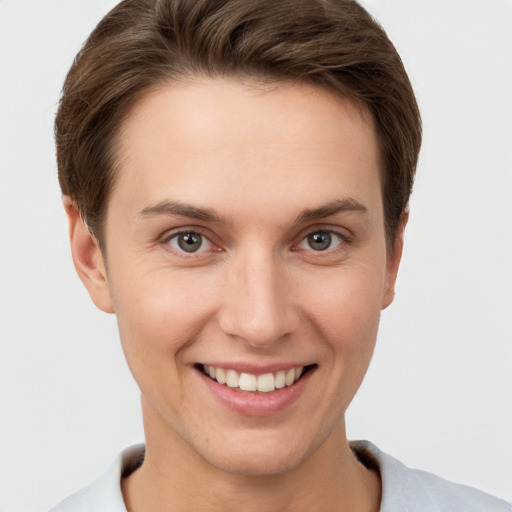 Joyful white young-adult female with short  brown hair and brown eyes