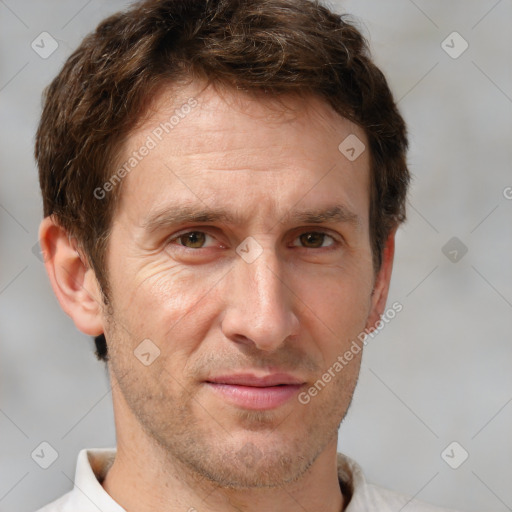 Joyful white adult male with short  brown hair and grey eyes