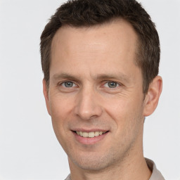 Joyful white adult male with short  brown hair and brown eyes