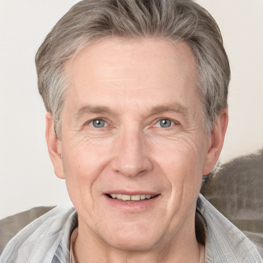 Joyful white adult male with short  blond hair and grey eyes