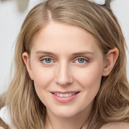 Joyful white young-adult female with long  brown hair and blue eyes