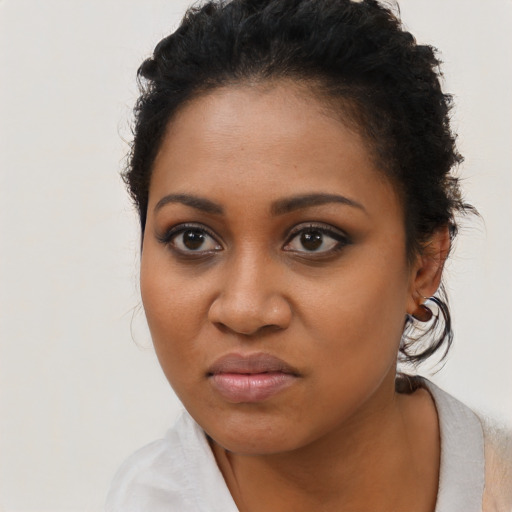 Joyful black young-adult female with short  brown hair and brown eyes