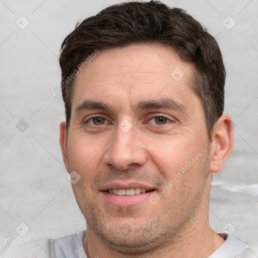 Joyful white adult male with short  brown hair and brown eyes