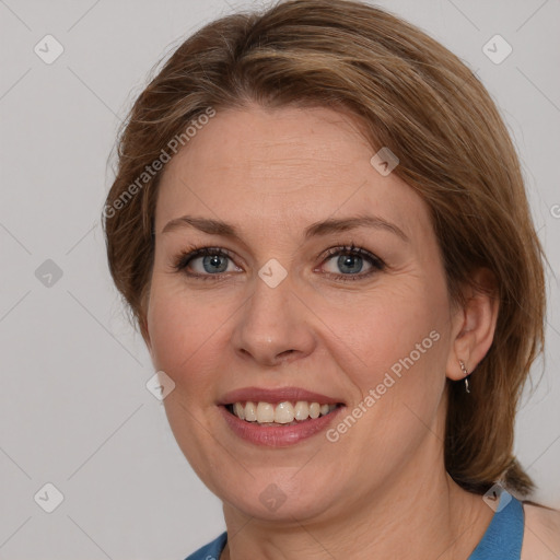 Joyful white adult female with medium  brown hair and blue eyes