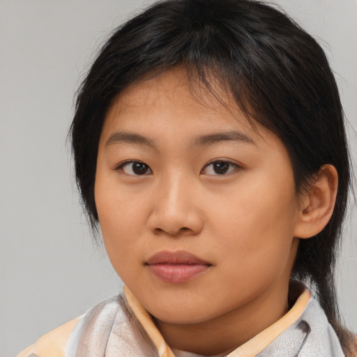 Joyful asian young-adult female with medium  brown hair and brown eyes