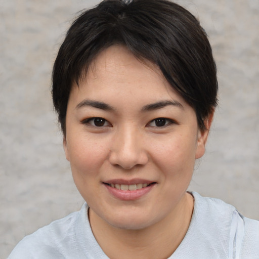 Joyful asian young-adult female with medium  brown hair and brown eyes