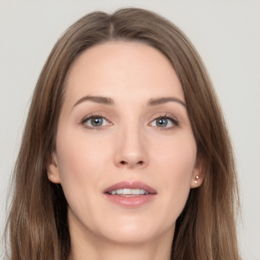 Joyful white young-adult female with long  brown hair and grey eyes