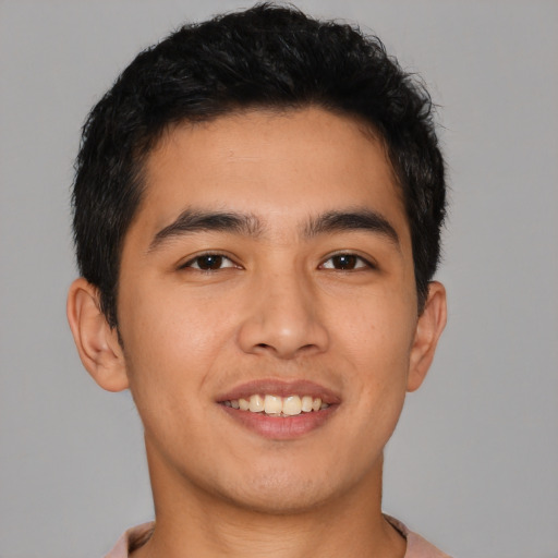 Joyful asian young-adult male with short  brown hair and brown eyes