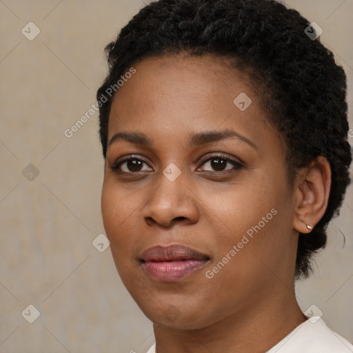 Joyful black young-adult female with short  brown hair and brown eyes