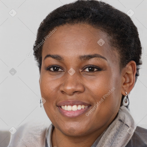 Joyful black young-adult female with short  brown hair and brown eyes