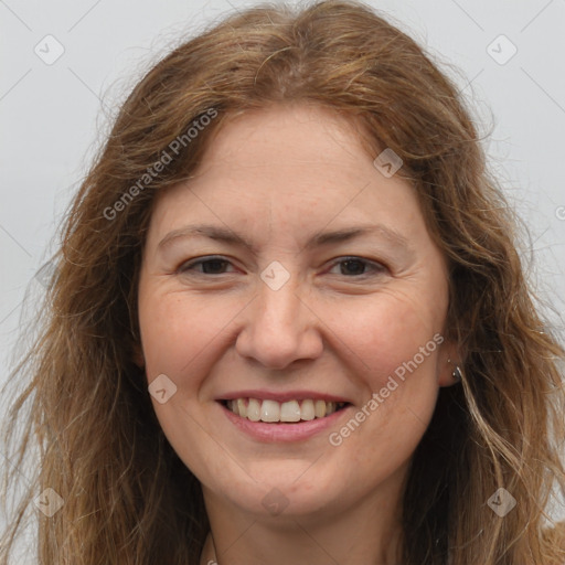 Joyful white adult female with long  brown hair and brown eyes