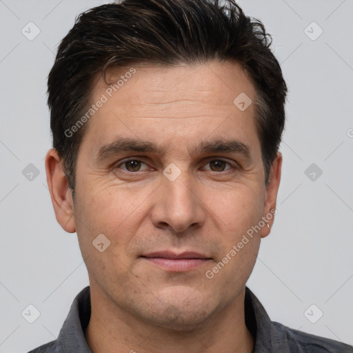 Joyful white adult male with short  brown hair and brown eyes