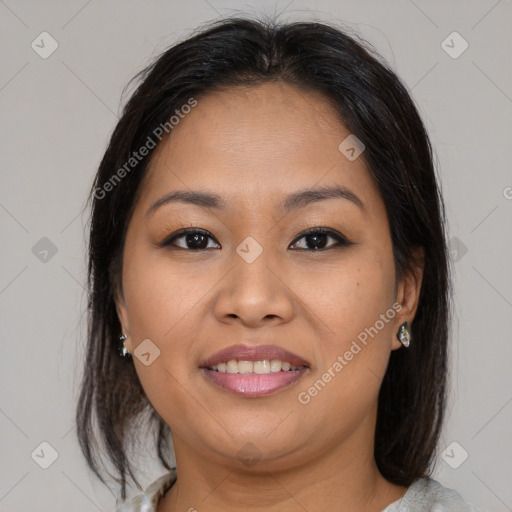 Joyful latino young-adult female with medium  brown hair and brown eyes