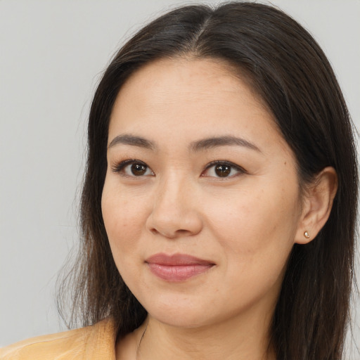 Joyful white young-adult female with long  brown hair and brown eyes