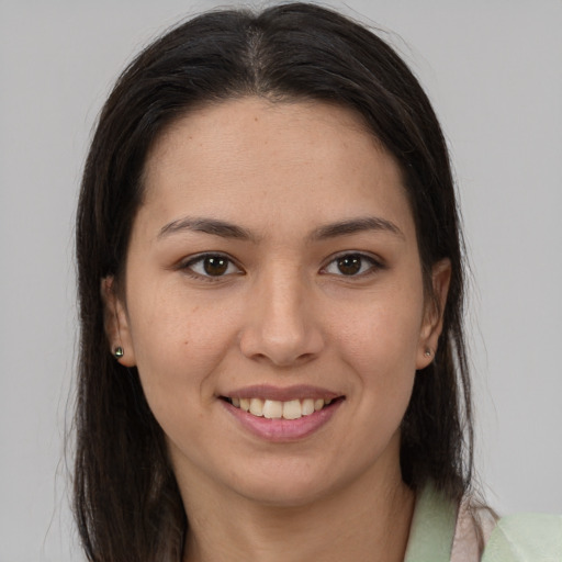 Joyful white young-adult female with long  brown hair and brown eyes