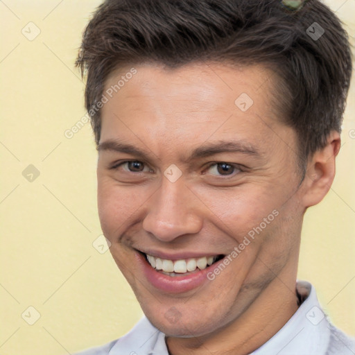 Joyful white adult male with short  brown hair and brown eyes