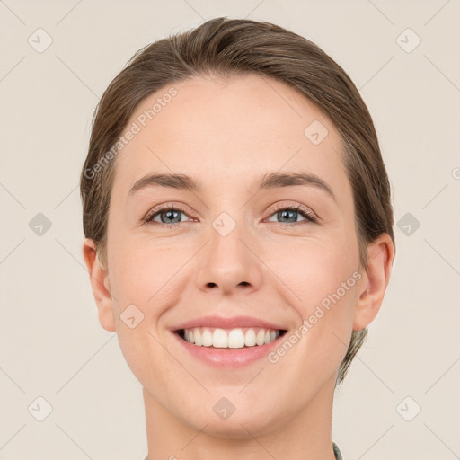 Joyful white young-adult female with medium  brown hair and green eyes