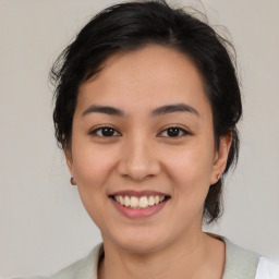 Joyful latino young-adult female with medium  brown hair and brown eyes