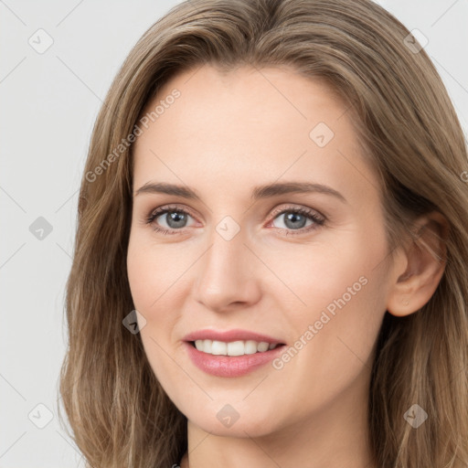 Joyful white young-adult female with long  brown hair and grey eyes