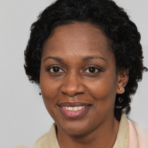 Joyful black adult female with short  brown hair and brown eyes