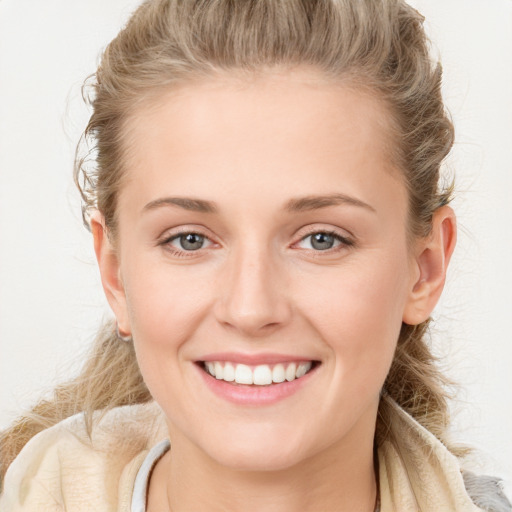 Joyful white young-adult female with long  brown hair and blue eyes