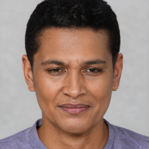Joyful latino young-adult male with short  brown hair and brown eyes