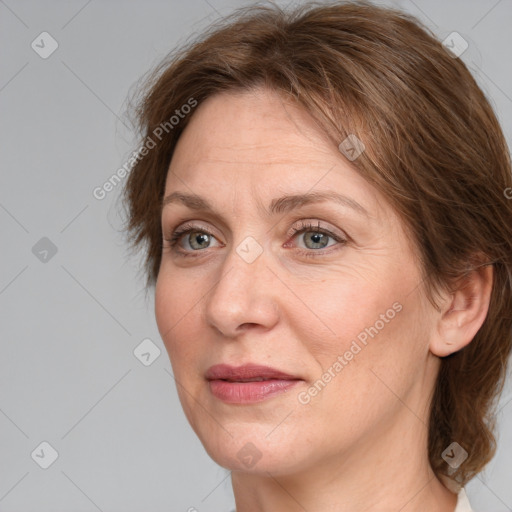 Joyful white adult female with medium  brown hair and grey eyes