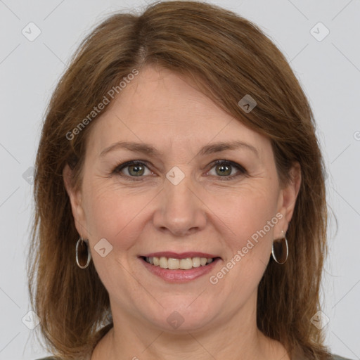 Joyful white adult female with medium  brown hair and grey eyes