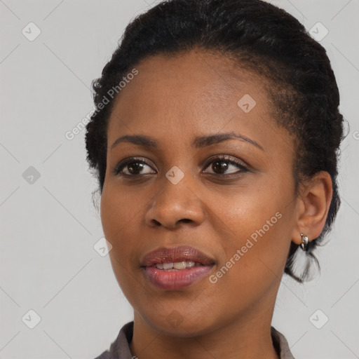 Joyful black young-adult female with short  brown hair and brown eyes