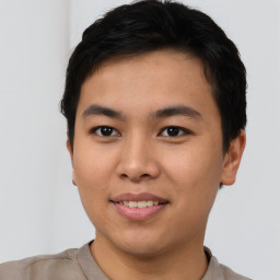 Joyful asian young-adult male with short  brown hair and brown eyes