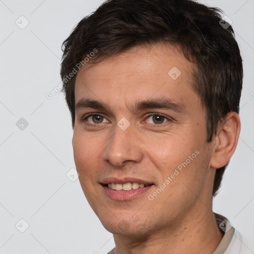 Joyful white young-adult male with short  brown hair and brown eyes