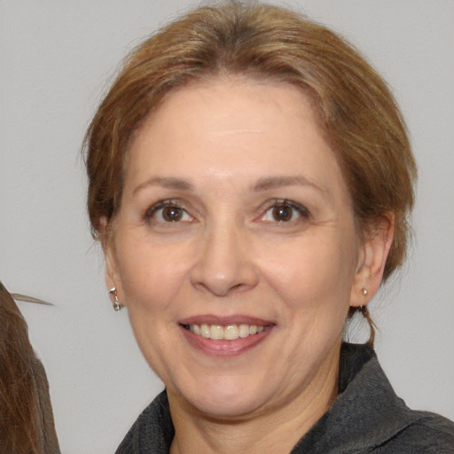 Joyful white adult female with medium  brown hair and brown eyes