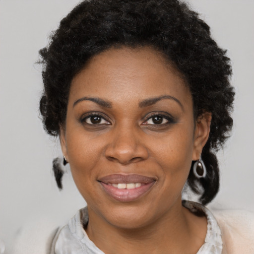 Joyful black young-adult female with medium  brown hair and brown eyes