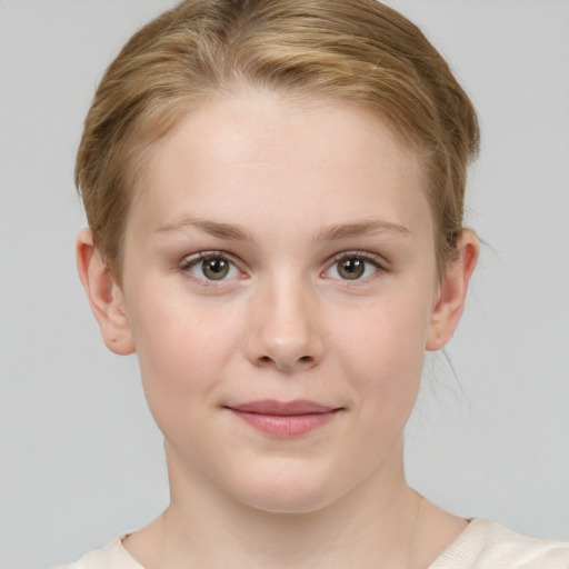 Joyful white child female with short  brown hair and grey eyes