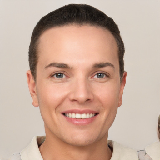 Joyful white young-adult male with short  brown hair and brown eyes