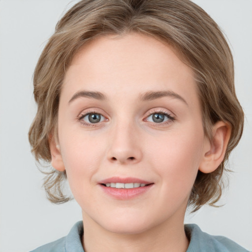 Joyful white young-adult female with medium  brown hair and blue eyes