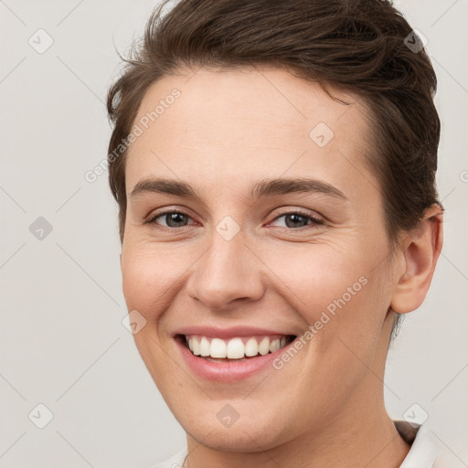 Joyful white young-adult female with short  brown hair and brown eyes