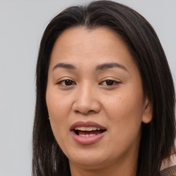 Joyful asian young-adult female with long  brown hair and brown eyes