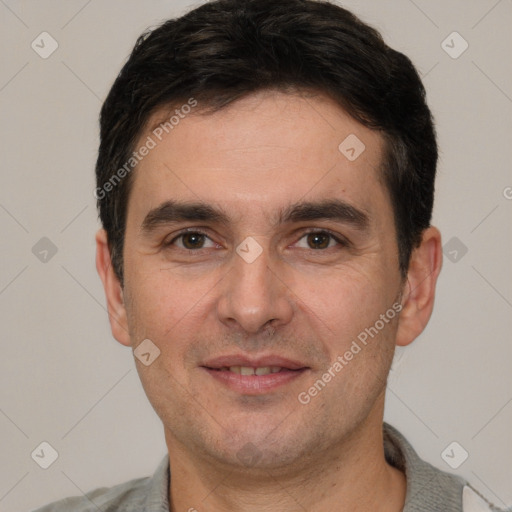 Joyful white young-adult male with short  black hair and brown eyes