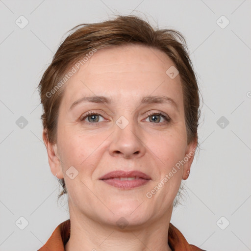 Joyful white adult female with medium  brown hair and grey eyes