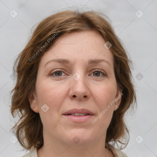 Joyful white adult female with medium  brown hair and grey eyes