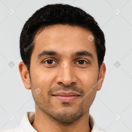 Joyful latino young-adult male with short  brown hair and brown eyes