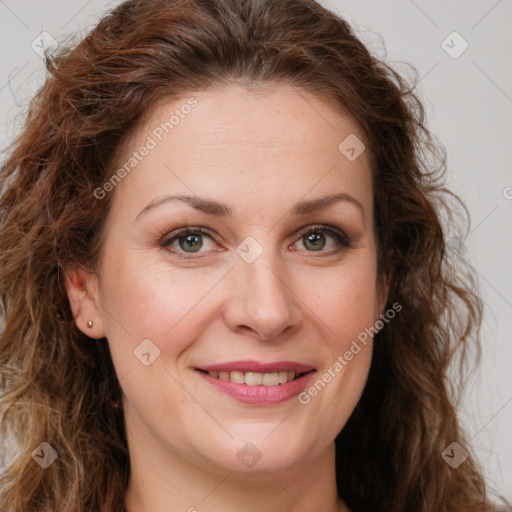 Joyful white adult female with long  brown hair and green eyes